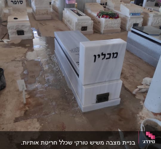 מצבות שיש עם שמות בבית עלמין מקורה